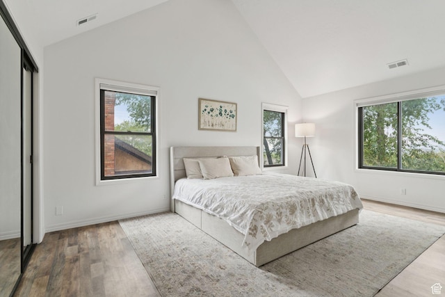 2255 E Camino Way Way S, Cottonwood Heights, UT 84121 - bedroom with multiple windows, wood finished floors, and high vaulted ceiling