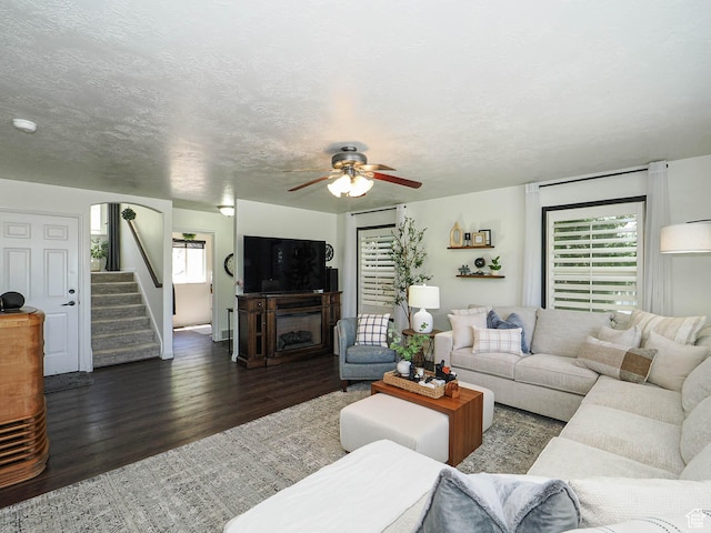 1152 E Gavin Cir, Draper, UT 84020 - living room with dark wood-type flooring, a ceiling fan, stairs, and a fireplace