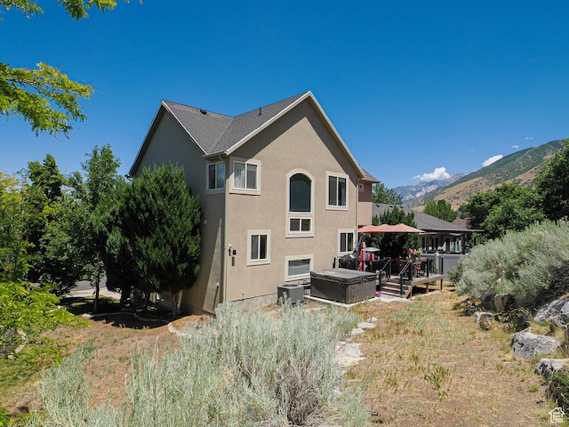 1152 E Gavin Cir, Draper, UT 84020 - back of property with stucco siding, a mountain view, and a hot tub