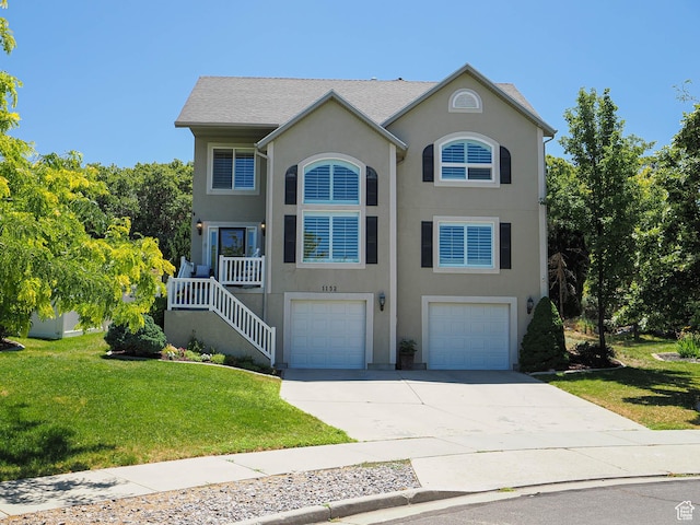 1152 E Gavin Cir, Draper, UT 84020 - view of front of property with an attached garage, driveway, a front lawn, stucco siding, and stairway