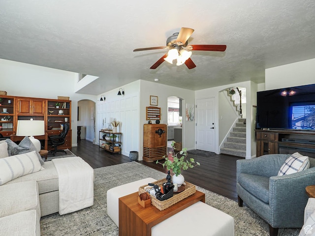 1152 E Gavin Cir, Draper, UT 84020 - living area featuring arched walkways, wood finished floors, a ceiling fan, stairway, and a textured ceiling