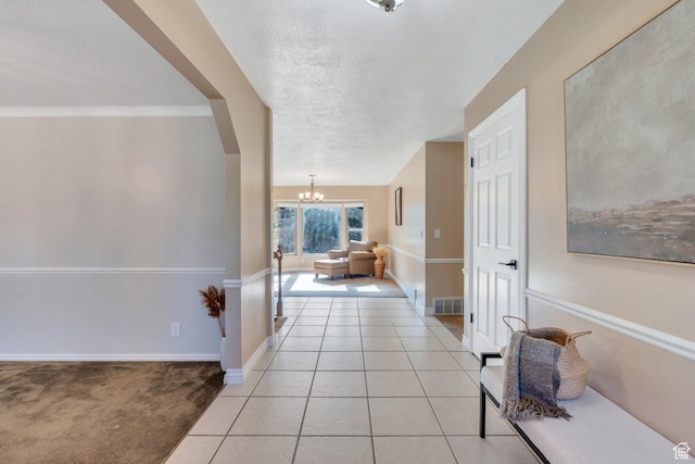 421 S 1400 E, Fruit Heights, UT 84037 - corridor with a chandelier, a textured ceiling, light tile patterned floors, arched walkways, and crown molding