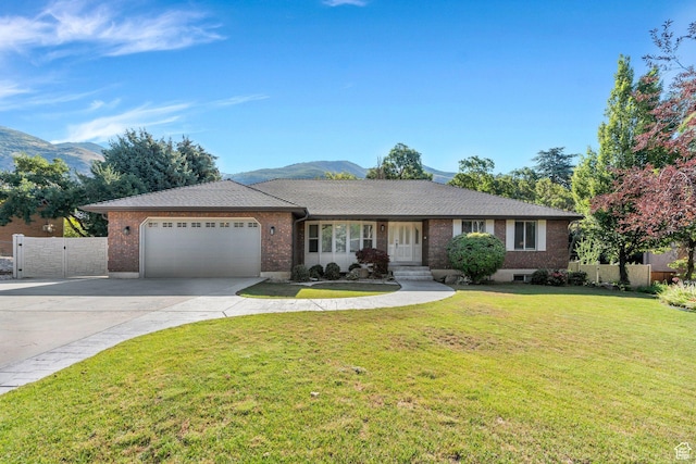 421 S 1400 E, Fruit Heights, UT 84037 - single story home with an attached garage, concrete driveway, brick siding, a mountain view, and a gate