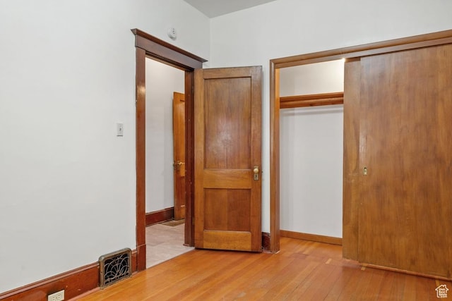 168 N T St E, Salt Lake City, UT 84103 - unfurnished bedroom featuring a closet and light wood-style flooring