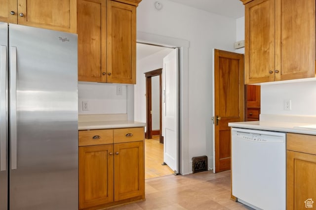 168 N T St E, Salt Lake City, UT 84103 - kitchen with freestanding refrigerator, dishwasher, light countertops, and brown cabinetry