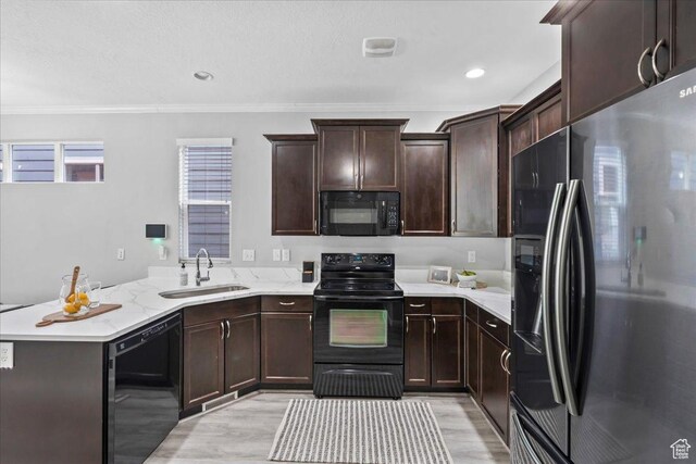 4988 W Currant Dr, South Jordan, UT 84009 - kitchen with black appliances, a peninsula, light wood-style flooring, ornamental molding, and dark brown cabinetry