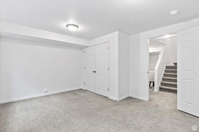 4988 W Currant Dr, South Jordan, UT 84009 - below grade area with carpet flooring, stairs, and a textured ceiling