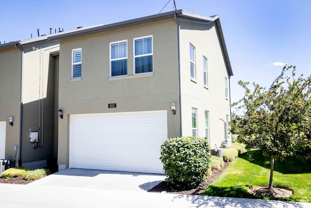 6122 W Lake Ave S, South Jordan, UT 84009 - view of property with stucco siding, driveway, and a garage