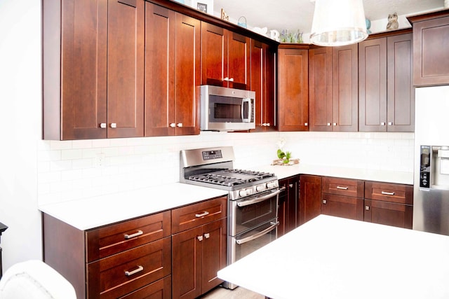 6122 W Lake Ave S, South Jordan, UT 84009 - kitchen featuring appliances with stainless steel finishes, light countertops, and decorative backsplash