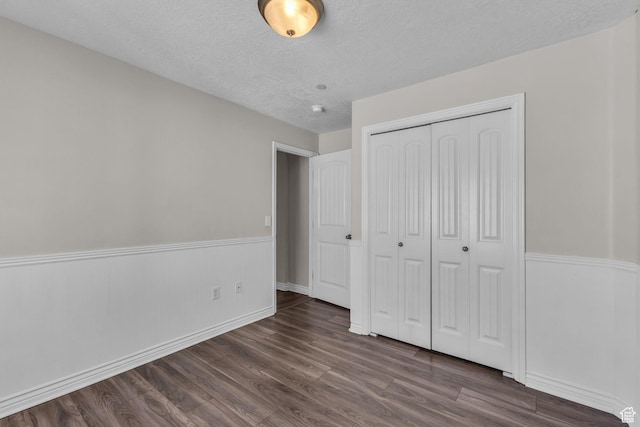 1195 W Dallin Dr Unit 304, Pleasant Grove, UT 84062 - unfurnished bedroom with a textured ceiling, dark wood-style floors, and a closet