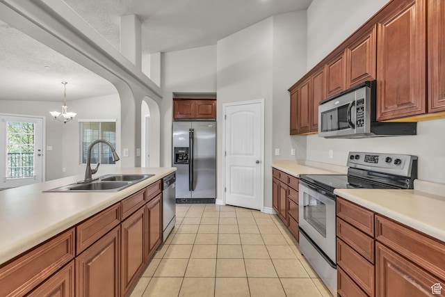 1195 W Dallin Dr Unit 304, Pleasant Grove, UT 84062 - kitchen featuring stainless steel appliances, light countertops, a chandelier, and arched walkways
