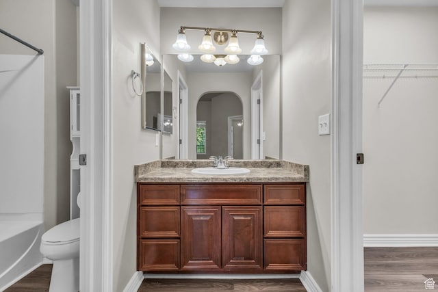 1195 W Dallin Dr Unit 304, Pleasant Grove, UT 84062 - bathroom with wood finished floors, vanity, a spacious closet, and shower / bath combination