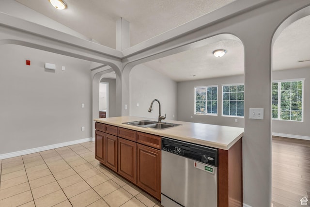 1195 W Dallin Dr Unit 304, Pleasant Grove, UT 84062 - kitchen featuring dishwasher, arched walkways, light countertops, healthy amount of natural light, and lofted ceiling