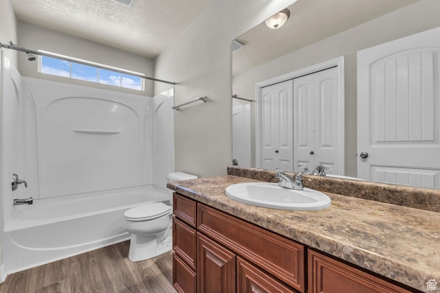 1195 W Dallin Dr Unit 304, Pleasant Grove, UT 84062 - bathroom with shower / bathtub combination, vanity, wood finished floors, and a textured ceiling