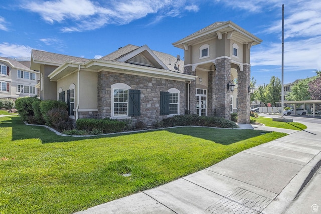 1195 W Dallin Dr Unit 304, Pleasant Grove, UT 84062 - view of front facade with stucco siding, stone siding, and a front yard