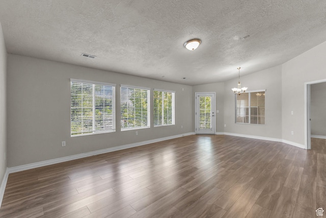 1195 W Dallin Dr Unit 304, Pleasant Grove, UT 84062 - unfurnished room featuring a chandelier, wood finished floors, and a textured ceiling