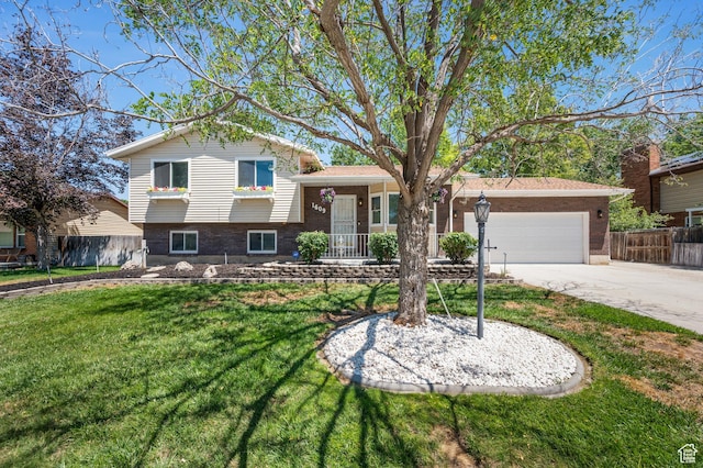 1609 E Sego Lily Dr, Sandy, UT 84092 - tri-level home with a garage, concrete driveway, and brick siding