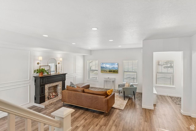4915 N Marble Fox Way Unit 126, Lehi, UT 84043 - living area with light wood finished floors, a brick fireplace, and recessed lighting