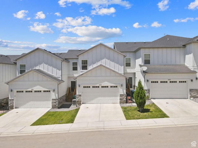 4915 N Marble Fox Way Unit 126, Lehi, UT 84043 - view of front of home featuring board and batten siding, stone siding, concrete driveway, and roof with shingles