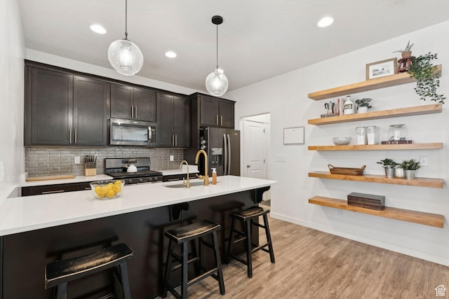 4915 N Marble Fox Way Unit 126, Lehi, UT 84043 - kitchen with appliances with stainless steel finishes, open shelves, backsplash, a kitchen bar, and recessed lighting