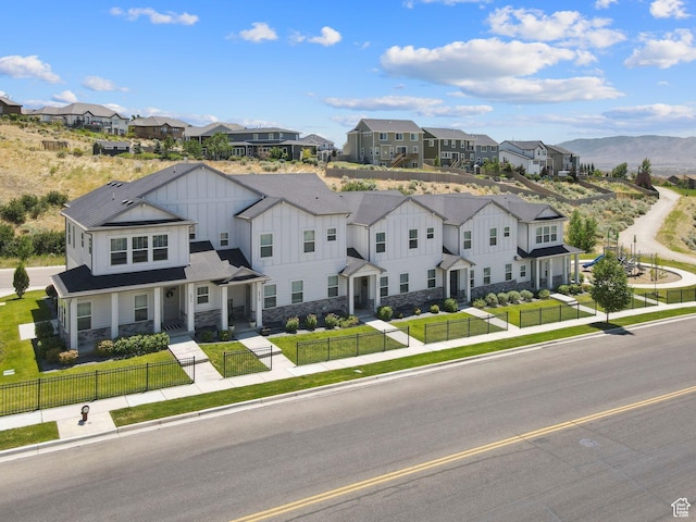 4915 N Marble Fox Way Unit 126, Lehi, UT 84043 - townhome / multi-family property featuring board and batten siding, a fenced front yard, a residential view, and stone siding