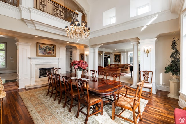 1781 Lorien Dr, Bountiful, UT 84010 - dining space with dark wood-type flooring, a high end fireplace, a high ceiling, crown molding, and decorative columns