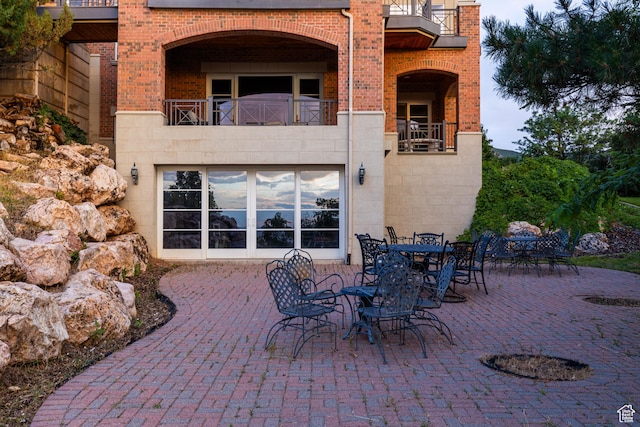 1781 Lorien Dr, Bountiful, UT 84010 - back of property with brick siding, a patio area, and a balcony