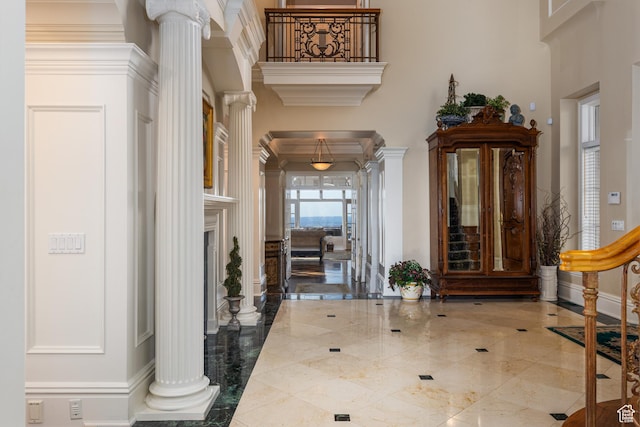 1781 Lorien Dr, Bountiful, UT 84010 - entrance foyer featuring ornate columns, a towering ceiling, marble tiled flooring, and crown molding