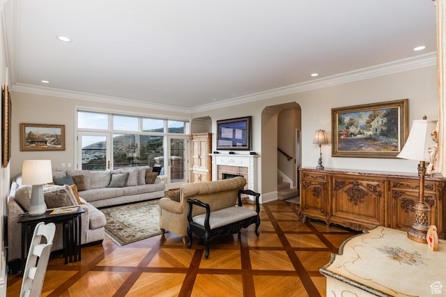 1781 Lorien Dr, Bountiful, UT 84010 - living room with crown molding, arched walkways, a fireplace, stairs, and recessed lighting