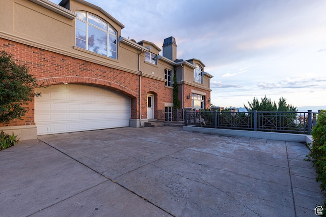 1781 Lorien Dr, Bountiful, UT 84010 - view of front of home featuring driveway, a garage, a chimney, and brick siding