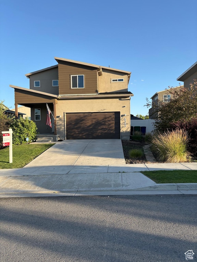 6343 W 7900 S, West Jordan, UT 84081 - modern home with an attached garage, driveway, and stucco siding