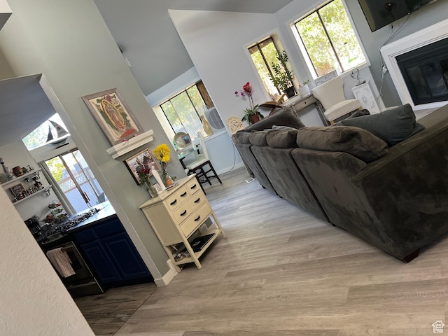 2267 W 4240 S, Taylorsville, UT 84129 - living area with a glass covered fireplace, light wood-type flooring, and a towering ceiling