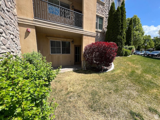 982 W 960 N Unit 101, Orem, UT 84057 - doorway to property with stone siding, a lawn, and stucco siding
