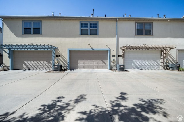 862 W Capraia Ct, Midvale, UT 84047 - rear view of house featuring stucco siding, an attached garage, and concrete driveway