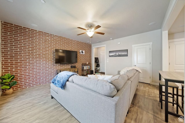 862 W Capraia Ct, Midvale, UT 84047 - living room with brick wall, ceiling fan, and light wood-type flooring