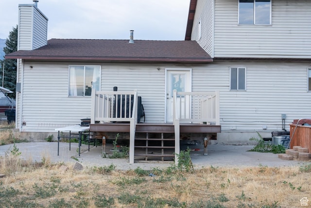 663 N 550 W, Orem, UT 84057 - rear view of house with a wooden deck, a chimney, roof with shingles, and a patio