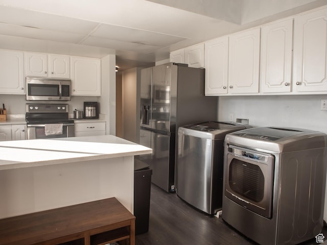 663 N 550 W, Orem, UT 84057 - kitchen with appliances with stainless steel finishes, independent washer and dryer, dark wood-style flooring, white cabinetry, and light countertops