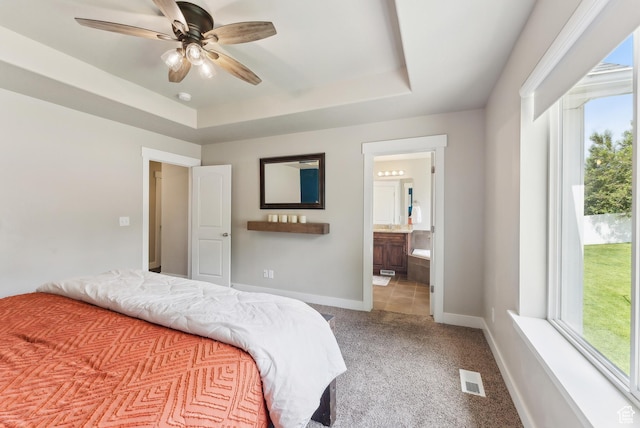 631 S Falkirk Rd, Heber City, UT 84032 - carpeted bedroom featuring a tray ceiling, ensuite bath, and a ceiling fan
