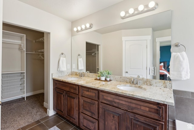631 S Falkirk Rd, Heber City, UT 84032 - ensuite bathroom featuring double vanity, a spacious closet, and tile patterned floors