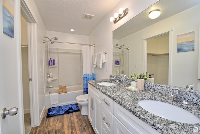 685 E 355 N, Vineyard, UT 84059 - full bathroom with shower / bath combination with curtain, double vanity, wood finished floors, a spacious closet, and a textured ceiling