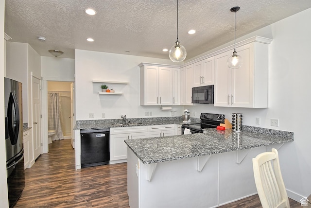 685 E 355 N, Vineyard, UT 84059 - kitchen with black appliances, a peninsula, dark wood-type flooring, dark stone countertops, and a textured ceiling