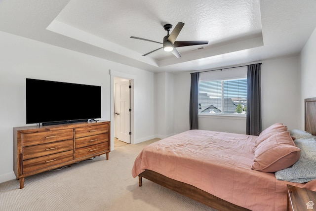 131 N Desert Sage Dr, Saratoga Springs, UT 84045 - bedroom featuring a tray ceiling, light carpet, ceiling fan, and a textured ceiling