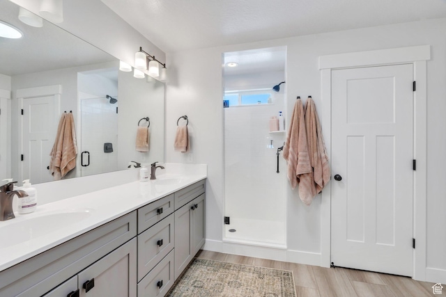 131 N Desert Sage Dr, Saratoga Springs, UT 84045 - bathroom featuring double vanity, a shower stall, and wood finished floors