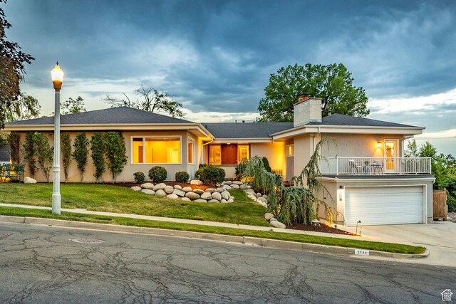 2722 E Eagle Way, Salt Lake City, UT 84108 - ranch-style house featuring concrete driveway, an attached garage, a chimney, a front lawn, and a balcony