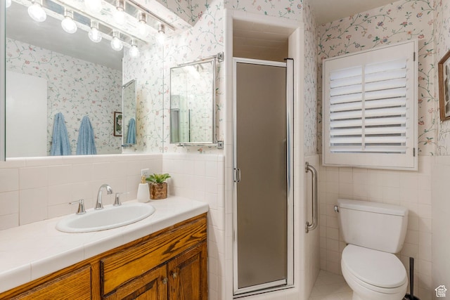 2722 E Eagle Way, Salt Lake City, UT 84108 - full bathroom with wallpapered walls, tile walls, vanity, a stall shower, and wainscoting
