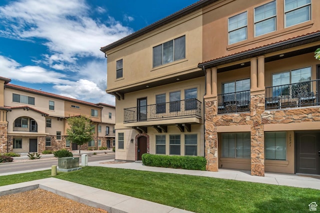 10925 N Marsala Dr, Highland, UT 84003 - view of front of house with stucco siding, a front yard, and stone siding