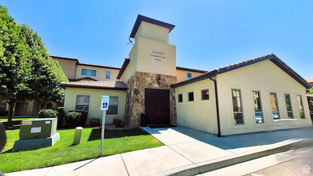 10925 N Marsala Dr, Highland, UT 84003 - view of front facade featuring stucco siding, stone siding, a front lawn, and a tiled roof