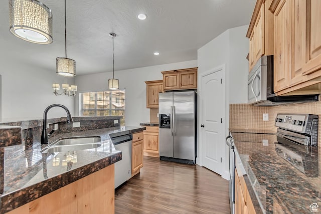 10925 N Marsala Dr, Highland, UT 84003 - kitchen with appliances with stainless steel finishes, dark wood finished floors, tasteful backsplash, hanging light fixtures, and recessed lighting