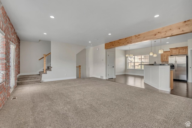 10925 N Marsala Dr, Highland, UT 84003 - unfurnished living room featuring recessed lighting, carpet floors, brick wall, and stairs