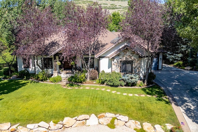 1307 N Dutch Highland Dr, Midway, UT 84049 - obstructed view of property with concrete driveway, a front lawn, stone siding, and a garage